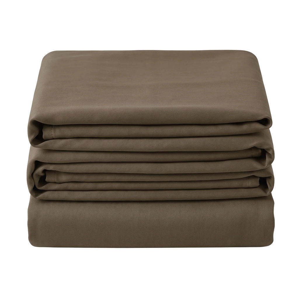 Noctura full blackout curtain folded in a stack on a white background